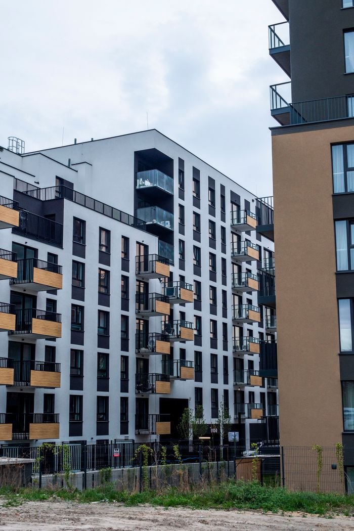 home-hero-bg Contemporary apartment blocks showcasing modern architectural design in urban setting.