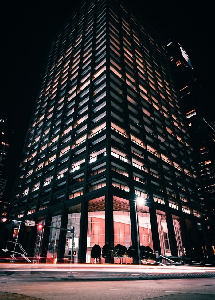 Stunning night view of an illuminated skyscraper in Houston, showcasing urban architecture and city lights.